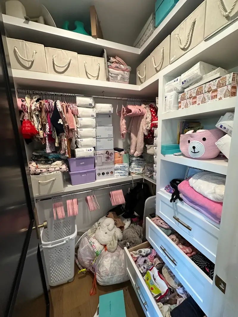 Before: West Hollywood kids' walk-in closet with toys, bags and open drawers spilling onto the floor